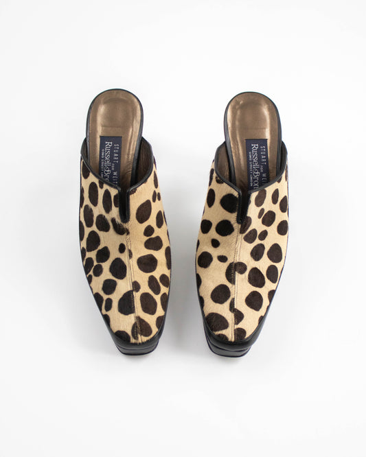 Pair of dalmatian print mules on a white background front view