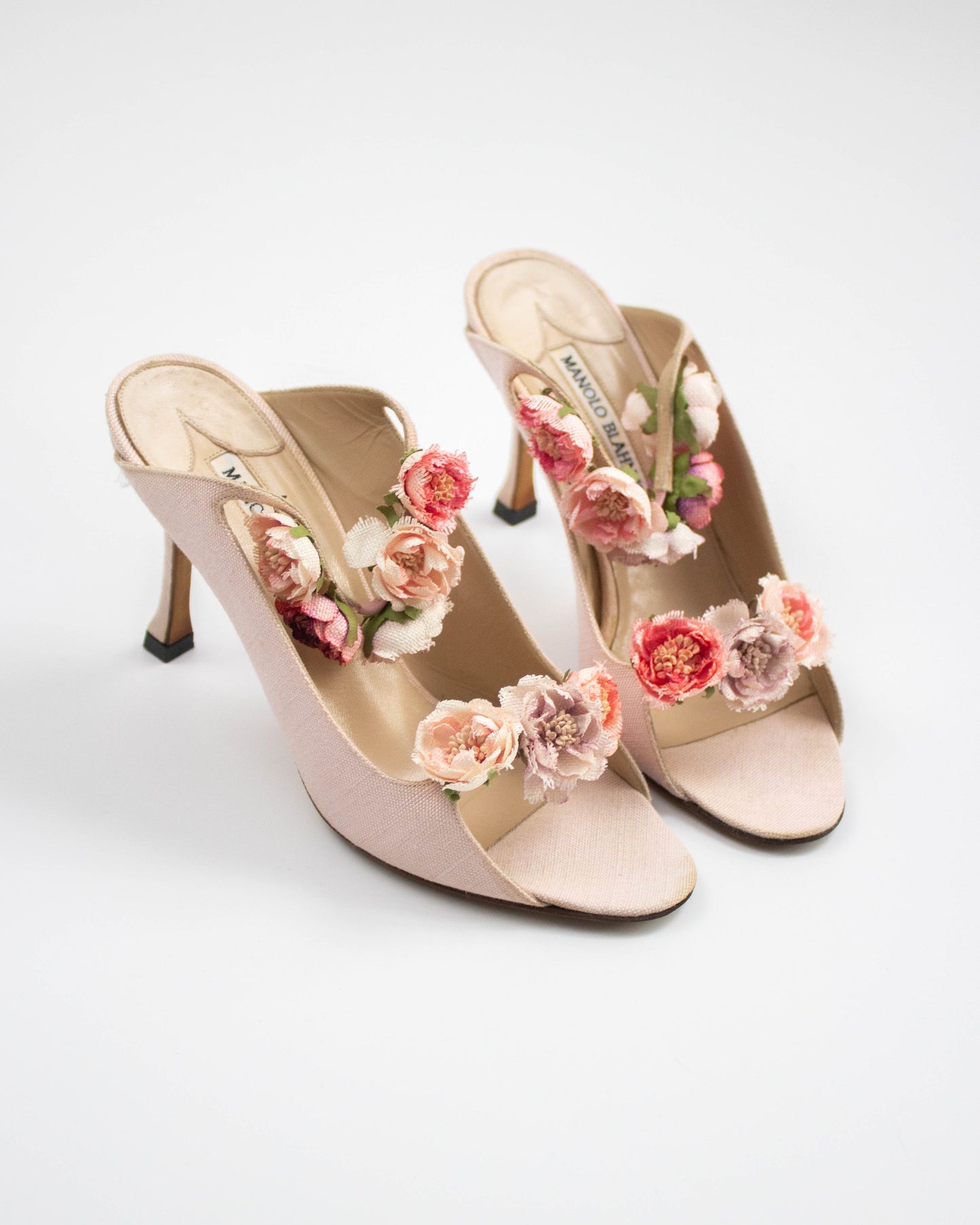 Pink Manolo Blahnik sandals with floral decorations side view