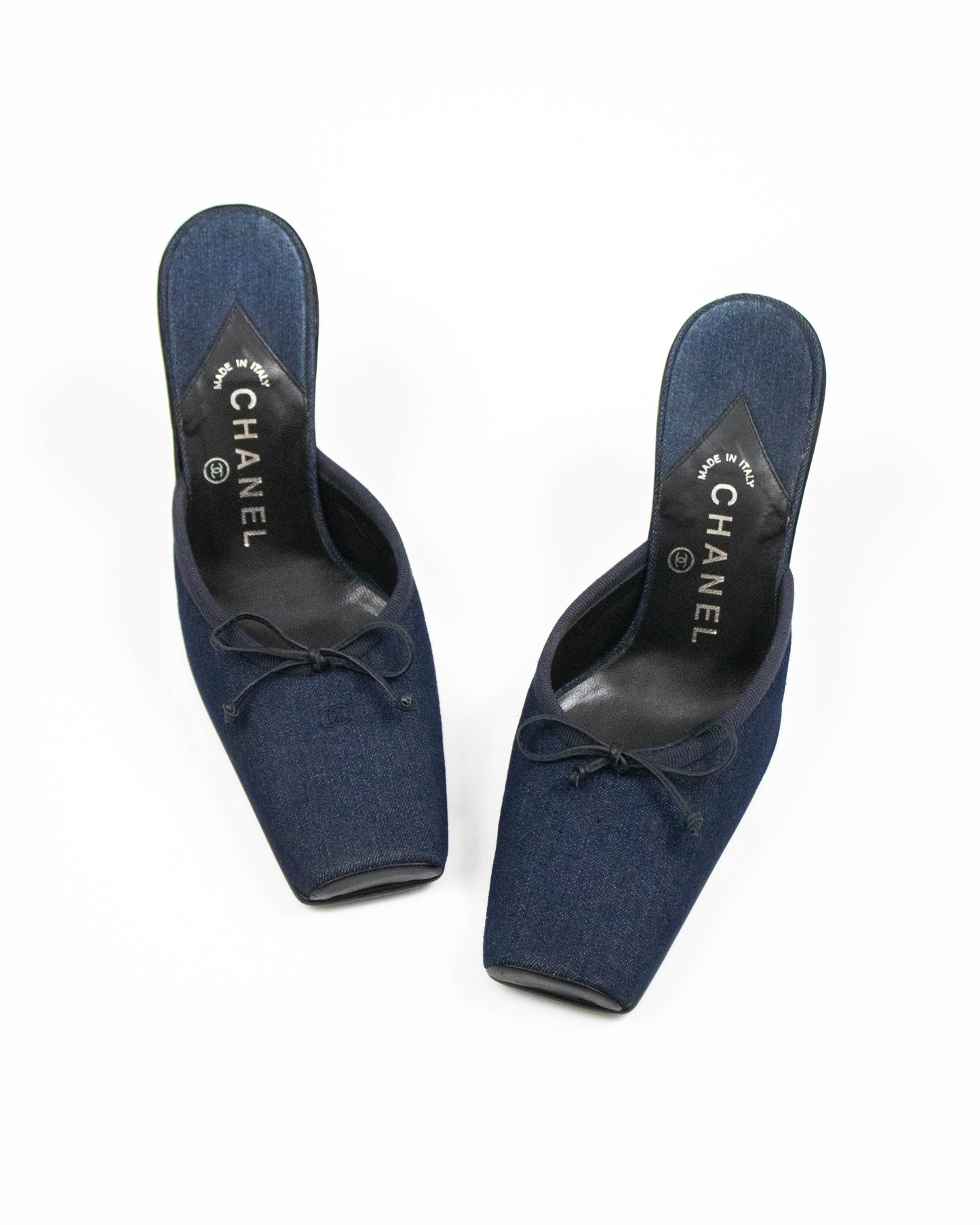 Pair of blue Chanel shoes on a white background front view