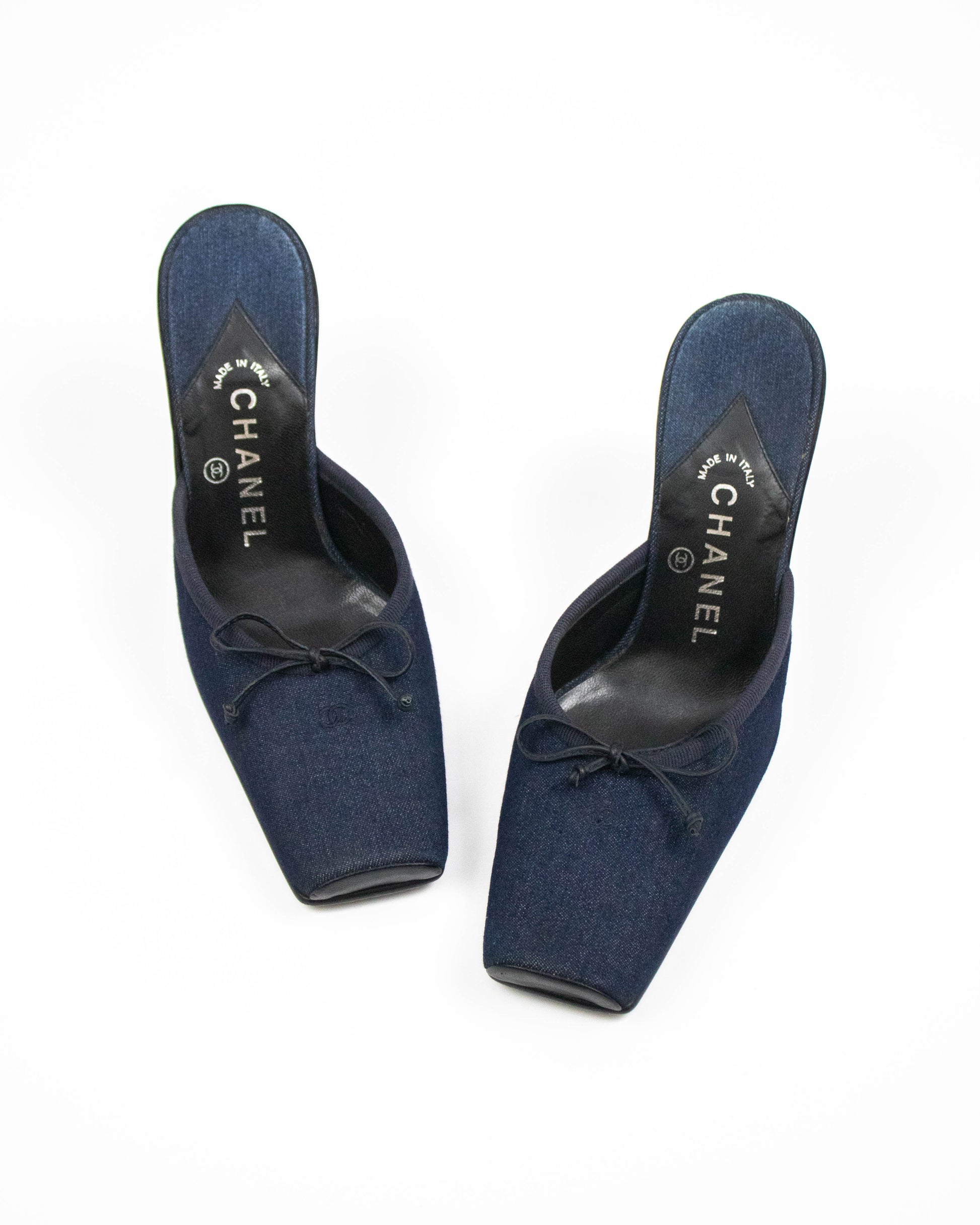 Pair of blue Chanel shoes on a white background front view