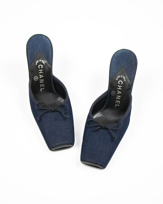 Pair of blue Chanel shoes on a white background front view