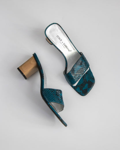 Teal snake print high-heeled shoes with wooden heel on a light gray background