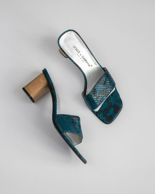 Teal snake print high-heeled shoes with wooden heel on a light gray background