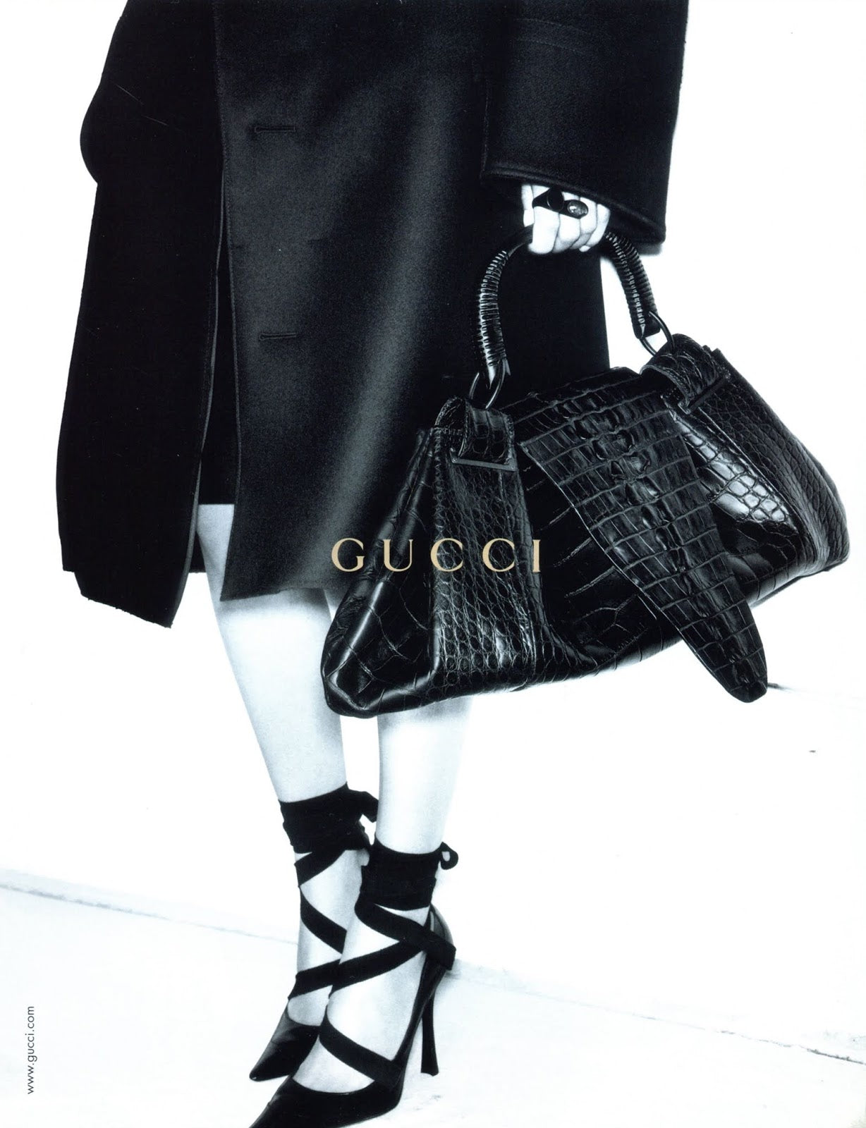 Pair of black pointed-toe Gucci heels with straps campaign photo