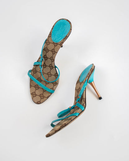 High-heeled sandal with turquoise strap and Gucci logo pattern side view