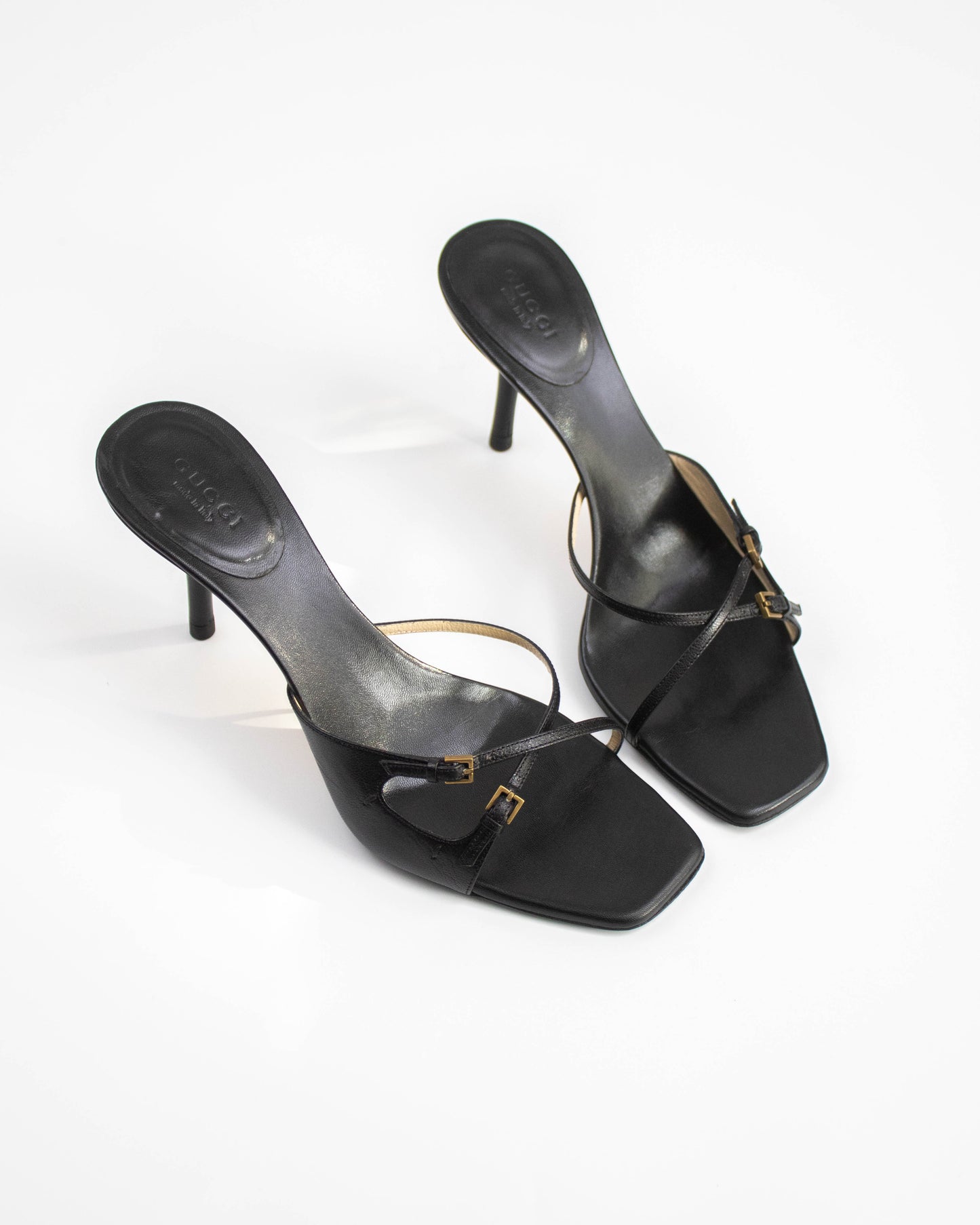 A pair of Vintage Gucci Black Cross Double Strap Heels top view