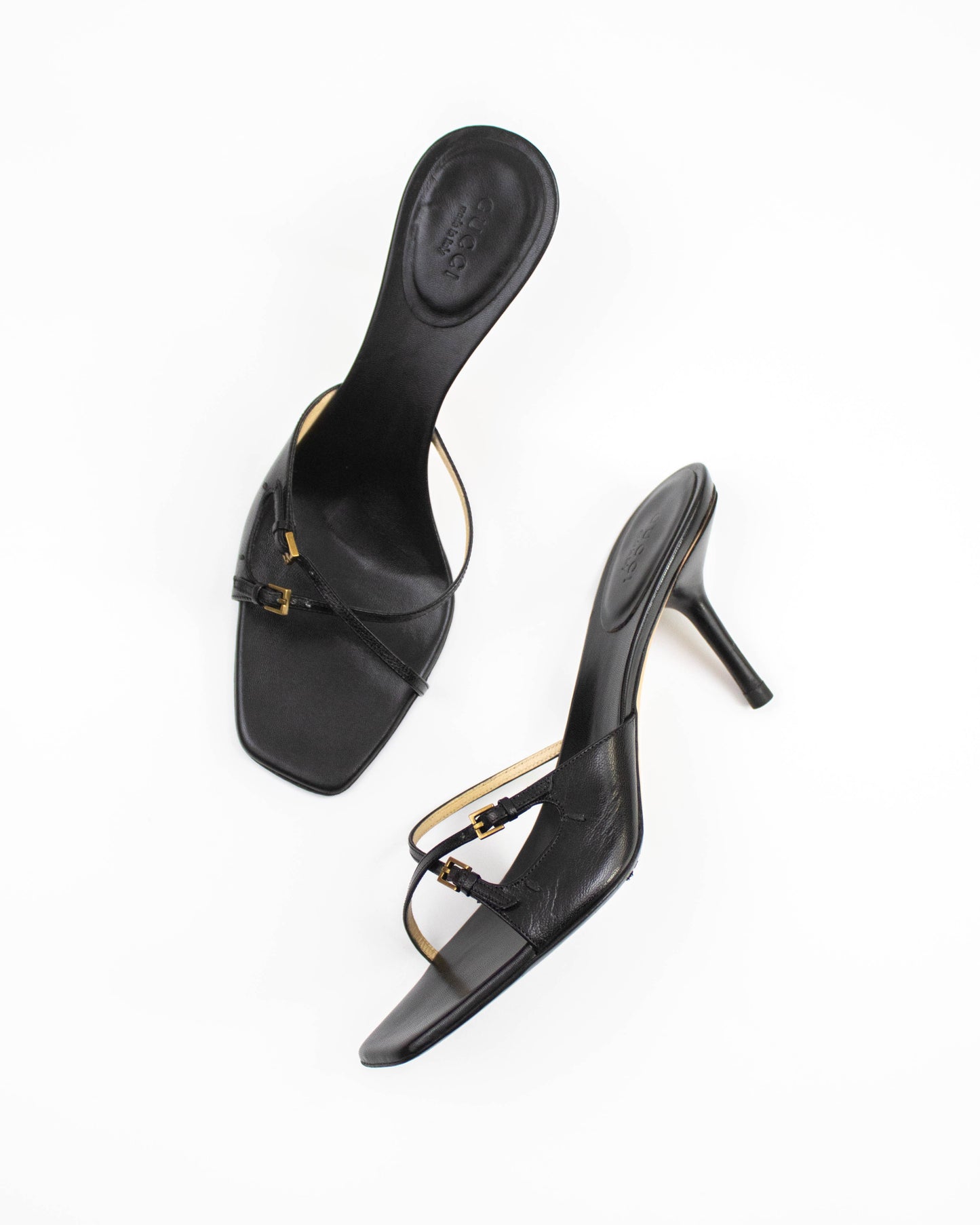A pair of Vintage Gucci Black Cross Double Strap Heels side view