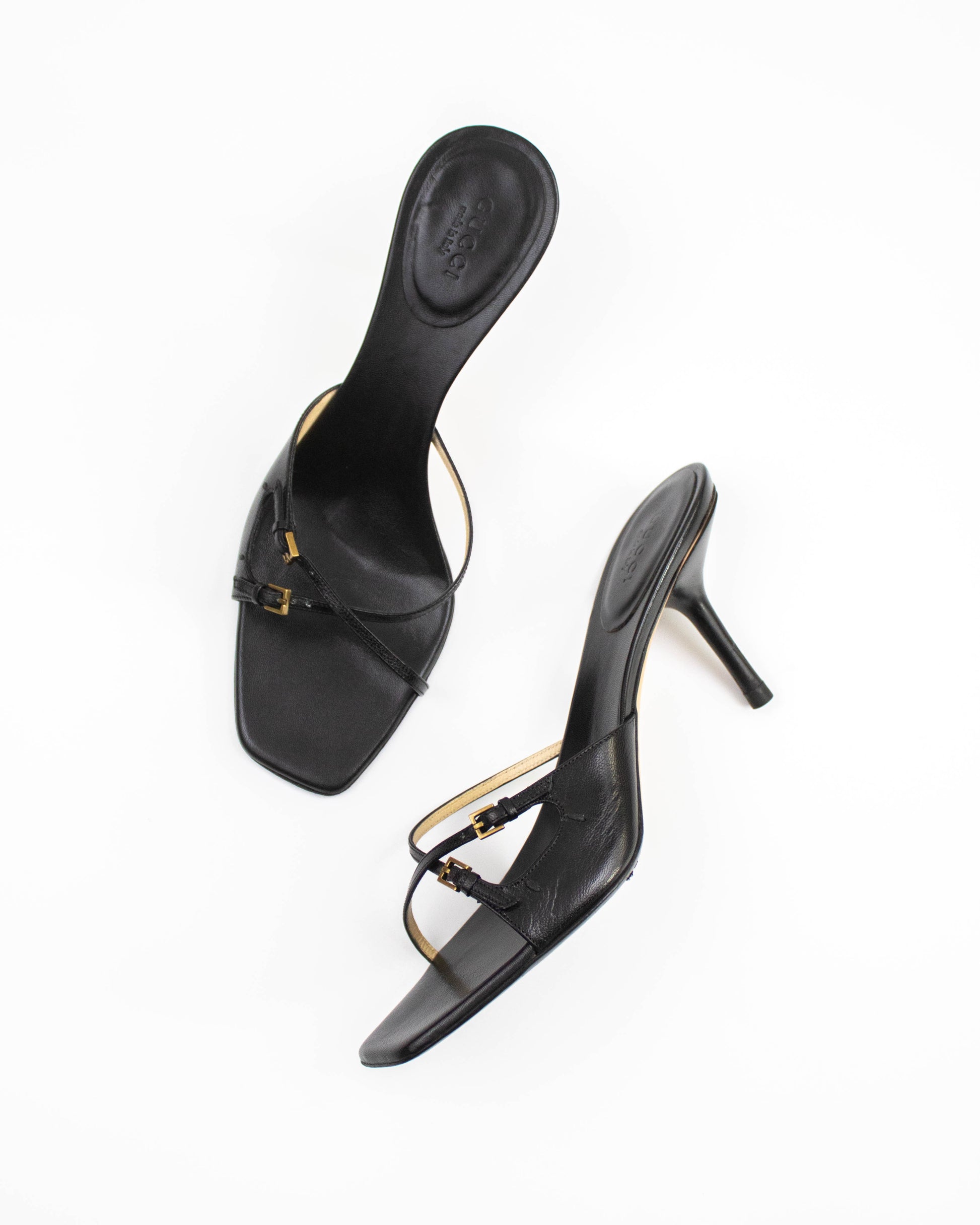 A pair of Vintage Gucci Black Cross Double Strap Heels side view