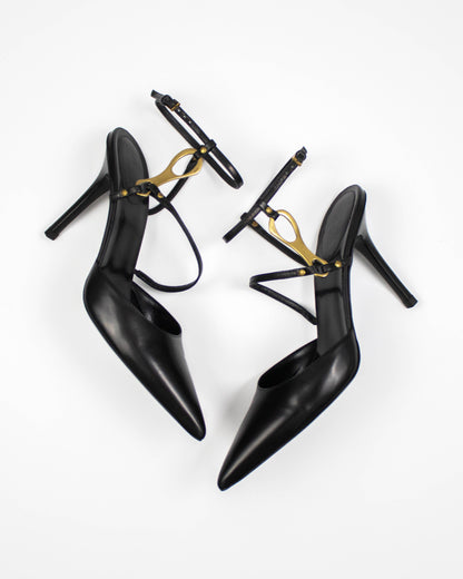 Black high-heeled Gucci shoes with gold horsebit accents front view 