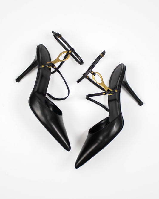 Black high-heeled Gucci shoes with gold horsebit accents front view 