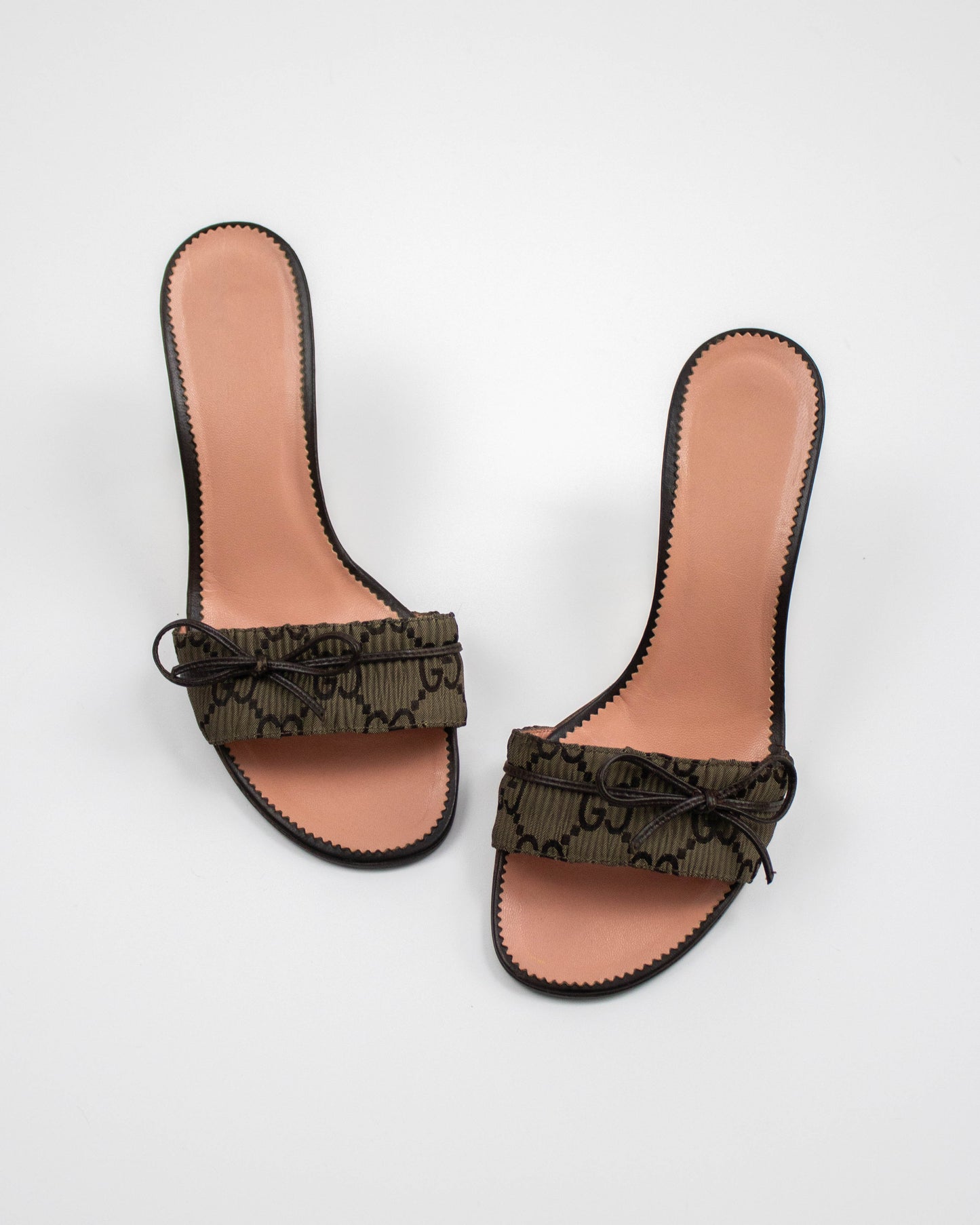 Pair of Gucci brown monogram mules  with bow detail top view