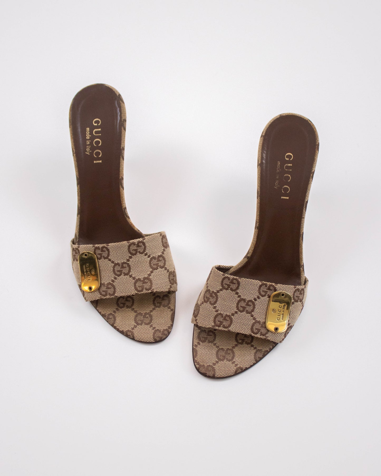 Pair of Gucci slide sandals with monogram pattern top view