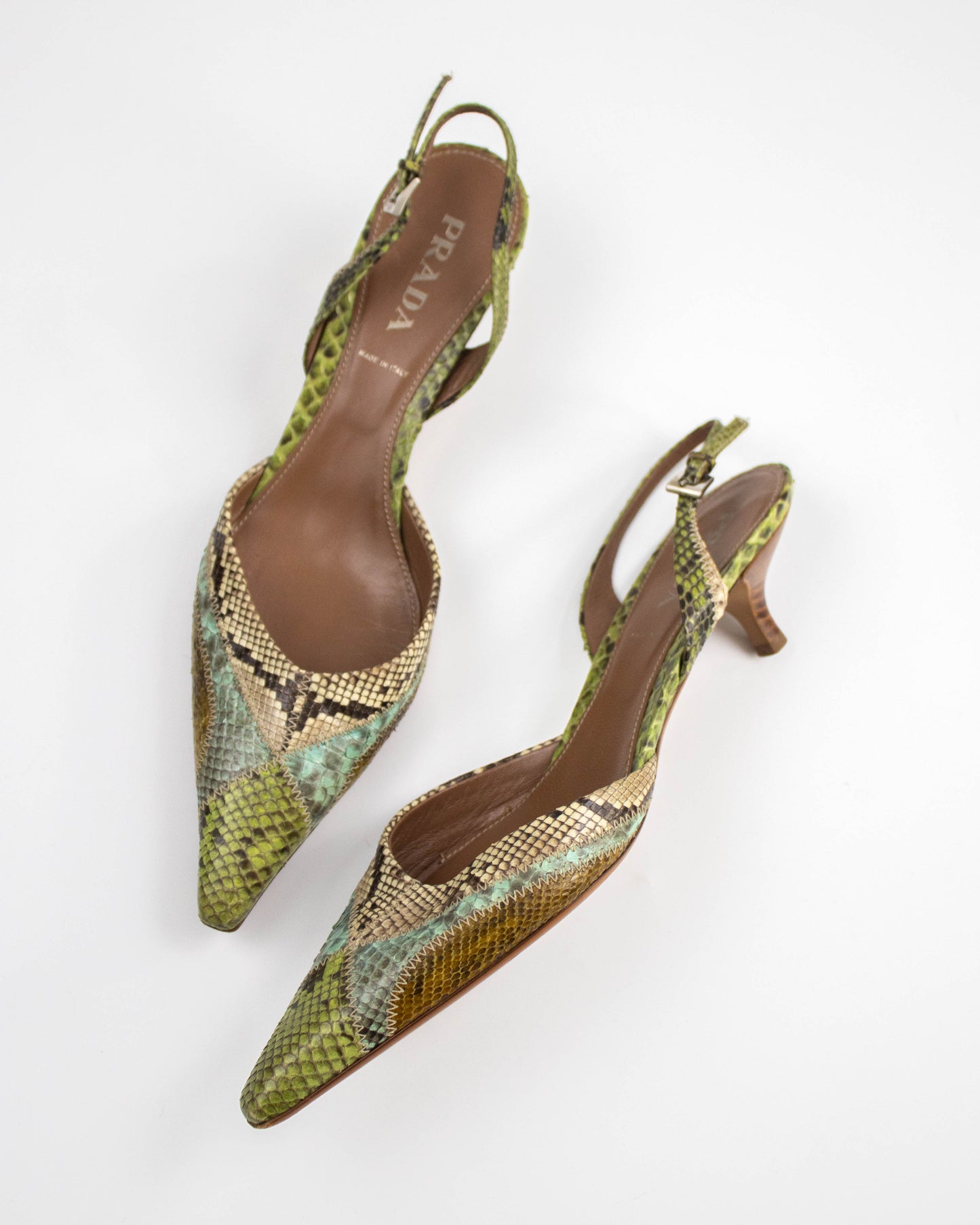 Pair of Prada snake print shoes on a white background side view