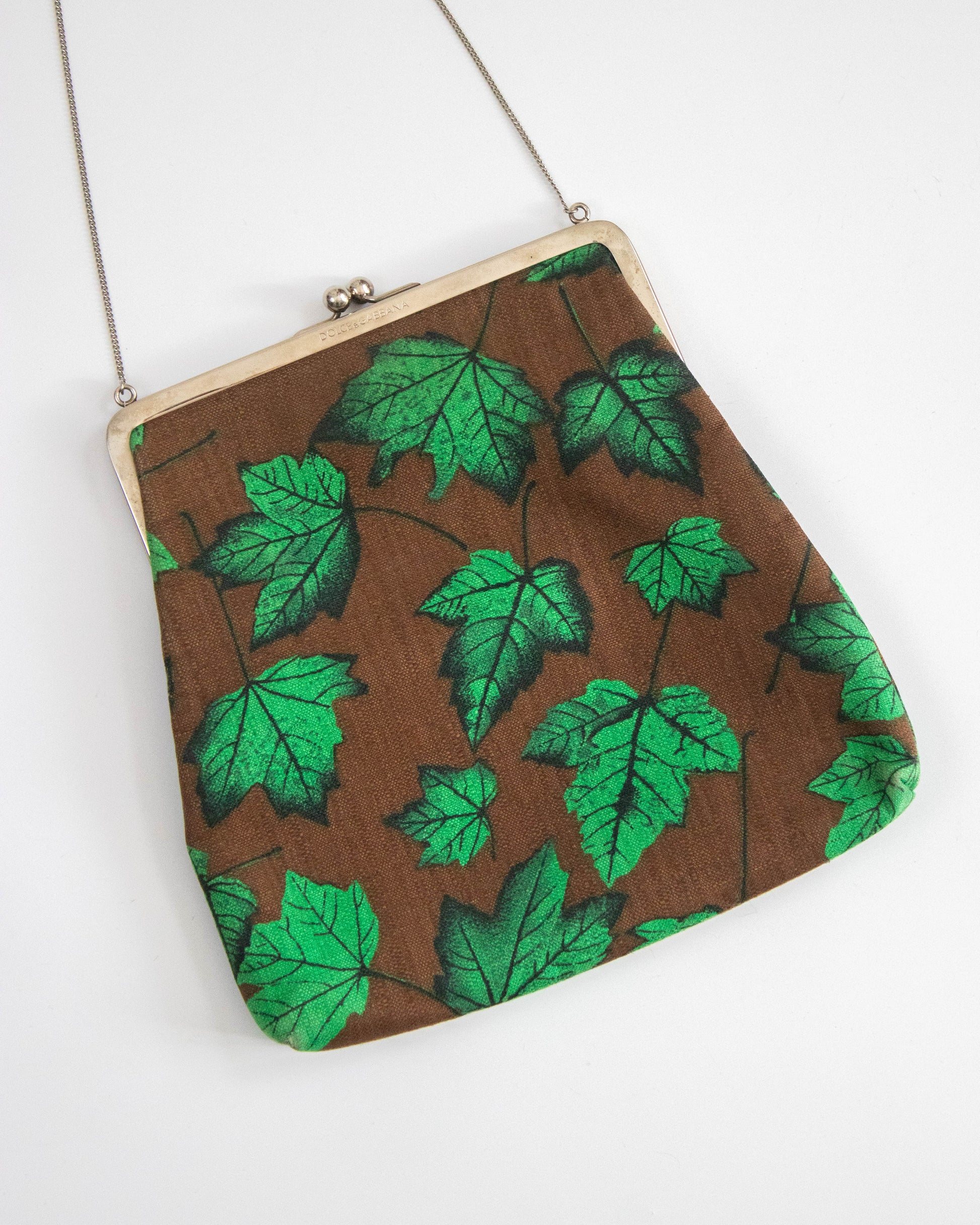 Dolce&Gabbana handbag with green leaf pattern on a white background