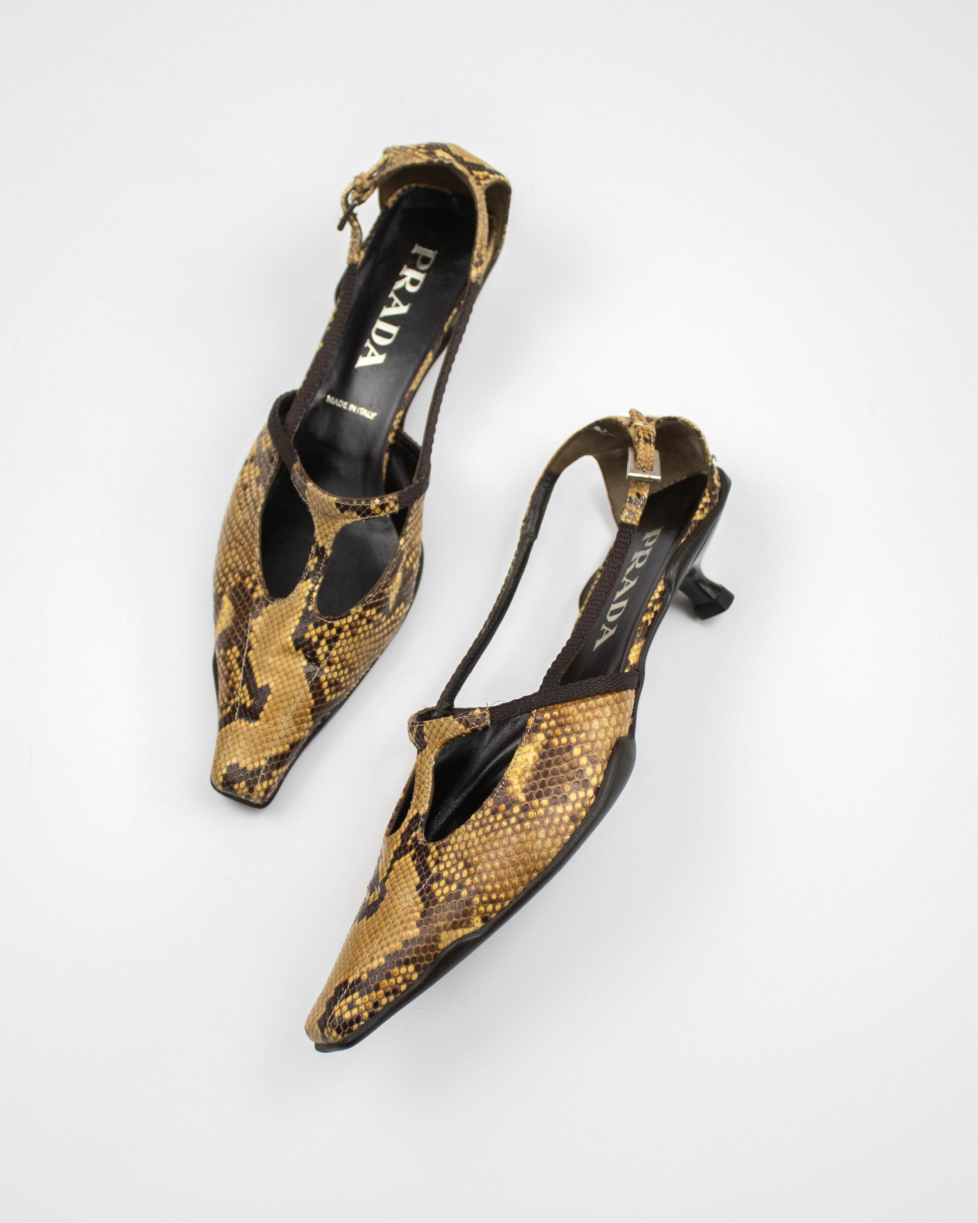 Snake print slingback heels with Prada logo on a white background side view