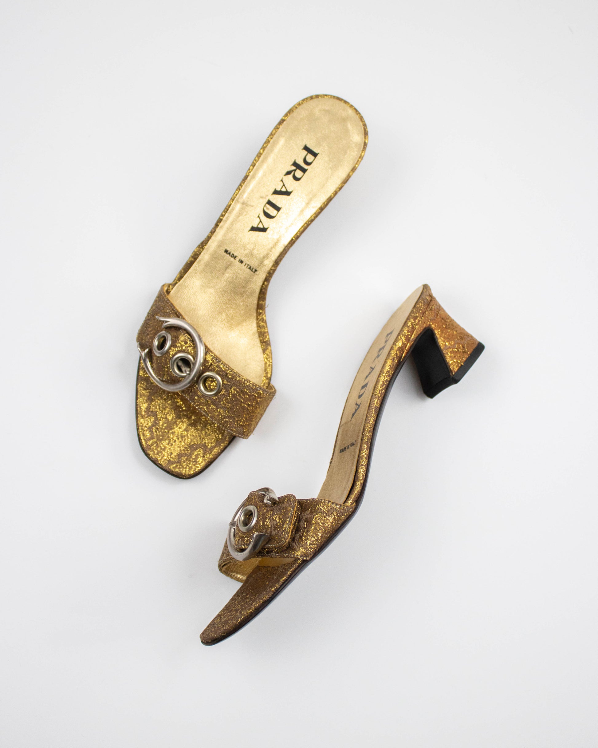 Gold brocade Prada shoes on a white background side view